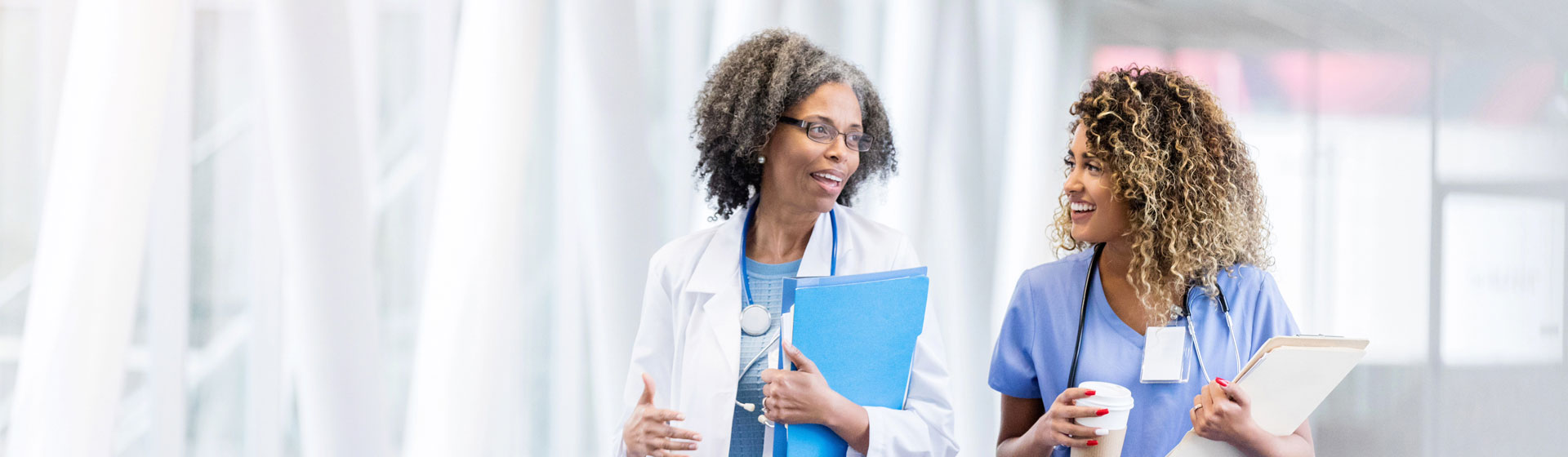 Female doctor speaking with female nurse
