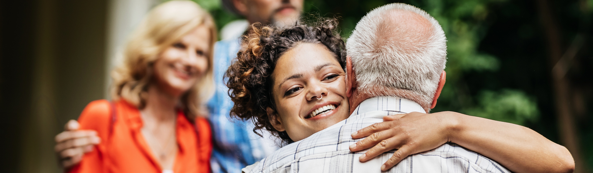 Daughter hugs father outside
